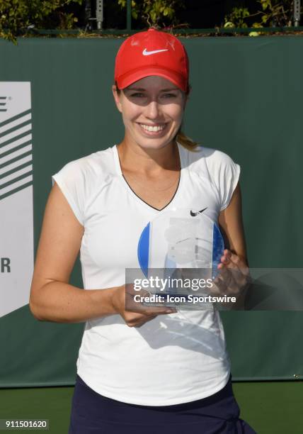 Danielle Collins stands with the women's championship trophy after defeating Sofya Zhuk in a three set finals match of the Oracle Challenger Series...