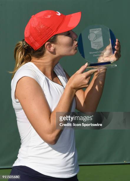 Danielle Collins stands with the women's championship trophy after defeating Sofya Zhuk in a three set finals match of the Oracle Challenger Series...