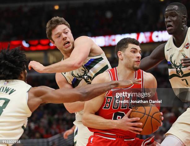 Zach LaVine of the Chicago Bulls moves between Sterling Brown, Matthew Dellavedova and Thon Maker of the Milwaukee Bucks at the United Center on...