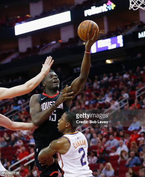 Clint Capela of the Houston Rockets drives over Isaiah Canaan of the Phoenix Suns in the fourth quarter at Toyota Center on January 28, 2018 in...
