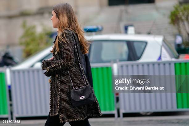 Guest wears a jacket and a bag, outside Chanel, during Paris Fashion Week -Haute Couture Spring/Summer 2018, on January 23, 2018 in Paris, France.