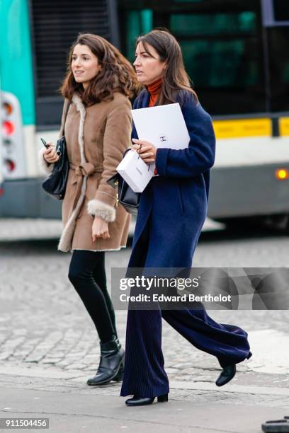 Guest wears a blue coat a red turtleneck, flare pants, outside Chanel, during Paris Fashion Week -Haute Couture Spring/Summer 2018, on January 23,...