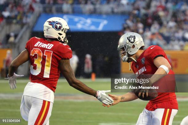 Kevin Byard of the Tennessee Titans celebrates with Derek Carr of the Oakland Raiders during the NFL Pro Bowl between the AFC and NFC at Camping...