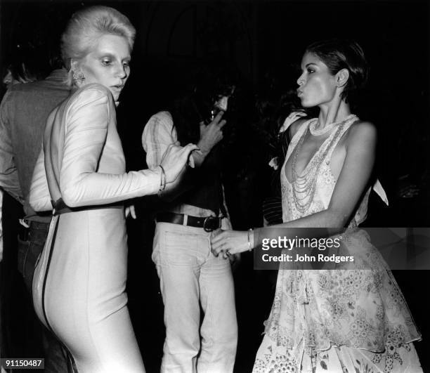 Photo of Bianca JAGGER and Angie BOWIE; Angie Bowie dancing with Bianca Jagger at the Ziggy Stardust retirement party held at the Cafe Royal