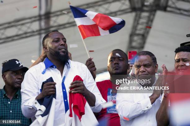 Former Dominican Major League baseball player Vladimir Guerrero holds a Dominican flag as he arrives at Las Americas Airport in Santo Domingo,...