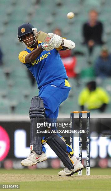 Sri Lankan cricketer Angelo Mathews palys a shot off the ball of England cricketer Graham Onions unseen during The ICC Champions Trophy match between...