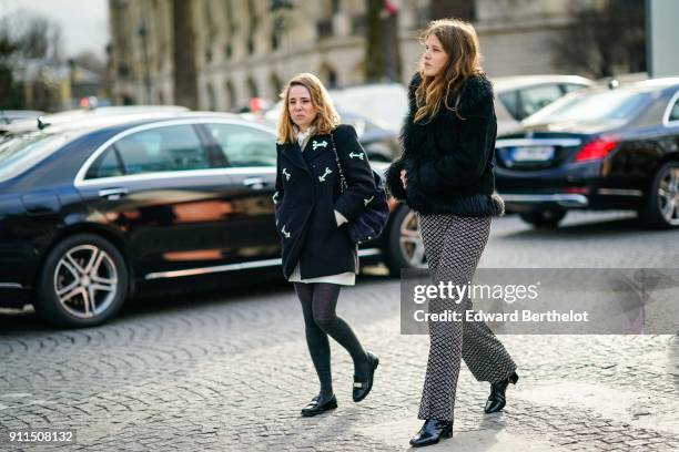 Guest wears a coat with fur, flare pants, outside Chanel, during Paris Fashion Week -Haute Couture Spring/Summer 2018, on January 23, 2018 in Paris,...