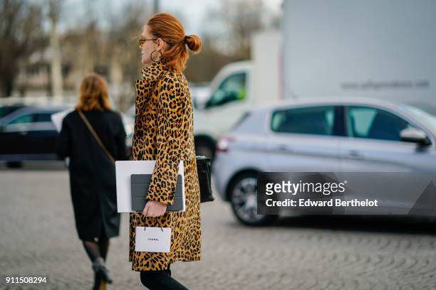 Guest wears a leopard print coat, has red hair, outside Chanel, during Paris Fashion Week -Haute Couture Spring/Summer 2018, on January 23, 2018 in...