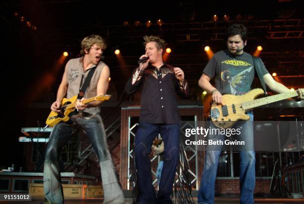 Photo of RASCAL FLATTS and Gary LeVOX and Joe Don ROONEY and Jay DeMARCUS, Group performing on stage L-R Joe Don Rooney, Gary LeVox and Jay DeMarcus