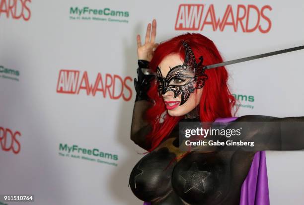 Adult film actress ShandaFay body painted to look like the character Batgirl from the "Batman" comic book franchise attends the 2018 Adult Video News...