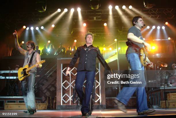 Photo of RASCAL FLATTS and Gary LeVOX and Joe Don ROONEY and Jay DeMARCUS, Group performing on stage L-R Joe Don Rooney, Gary LeVox and Jay DeMarcus