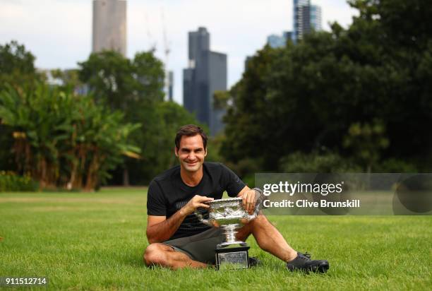 Roger Federer of Switzerland poses with the Norman Brookes Challenge Cup after winning the 2018 Australian Open Men's Singles Final, at Government...