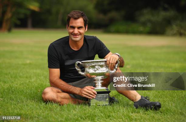 Roger Federer of Switzerland poses with the Norman Brookes Challenge Cup after winning the 2018 Australian Open Men's Singles Final, at Government...