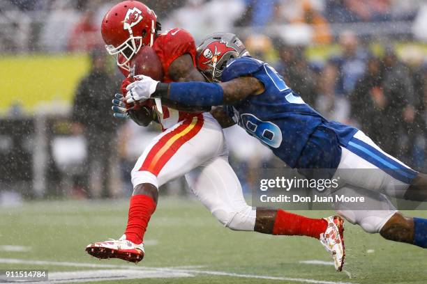 Linebacker Kwon Alexander of the Tampa Bay Buccaneers from the NFC Team forces a fumble on a punt return by Tyreek Hill of the Kansas City Chiefs...