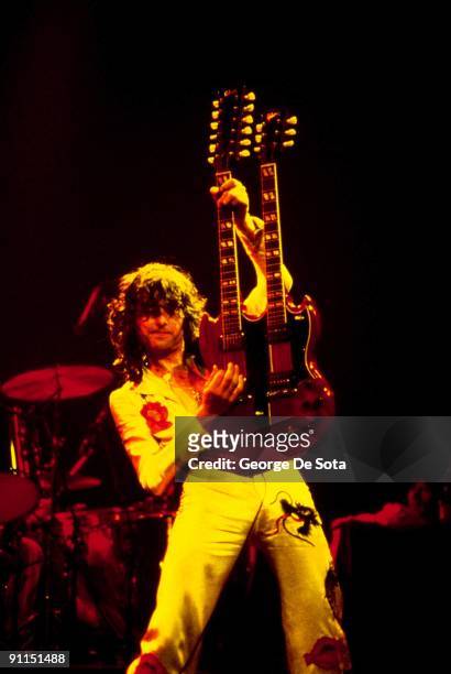 Photo of Jimmy PAGE and LED ZEPPELIN, Jimmy Page performing live onstage. Nearly full length shot, holding guitar up, playing Gibson EDS-1275...