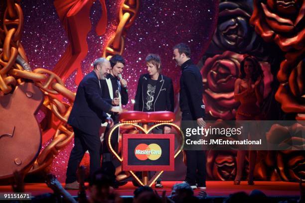 Photo of Chris WOLSTENHOLME and Dominic HOWARD and Matt BELLAMY and MUSE, L-R: Keith Allen presenting Matt Bellamy, Dominic Howard, Chris...
