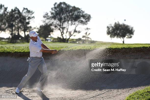Ryan Palmer plays a shot from a bunker on the 14th hole during the final round of the Farmers Insurance Open at Torrey Pines South on January 28,...