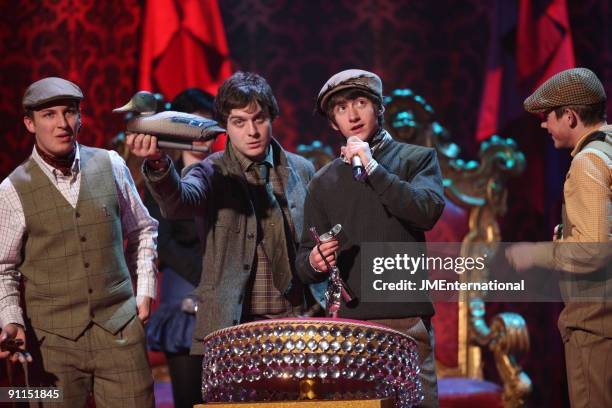 Photo of Matt HELDERS and Nick O'MALLEY and Alex TURNER and Jamie COOK and ARCTIC MONKEYS, The Arctic Monkeys on stage accepting the British Group...