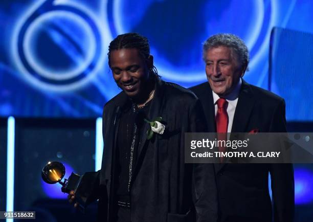 Recording artists Kendrick Lamar accepts the Best Rap/Sung Performance Grammy for 'Loyalty' from Tony Bennett during the 60th Annual Grammy Awards...