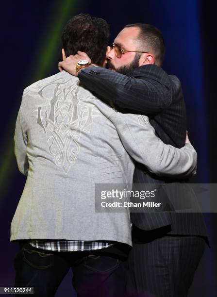 Adult film director/producer Kevin Moore is hugged after being brought onstage by adult film director/producer Greg Lansky to speak about Moore's...