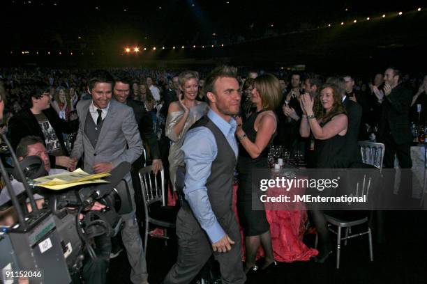 Photo of TAKE THAT and Gary BARLOW and Howard DONALD and Jason ORANGE, L-R Jason Orange, Howard Donald and Gary Barlow being applauded at the head...