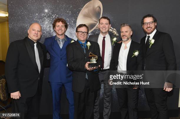 Chair of the Board for The Recording Academy John Poppo and recording artists Infamous Stringdusters pose backstage at the Premiere Ceremony during...