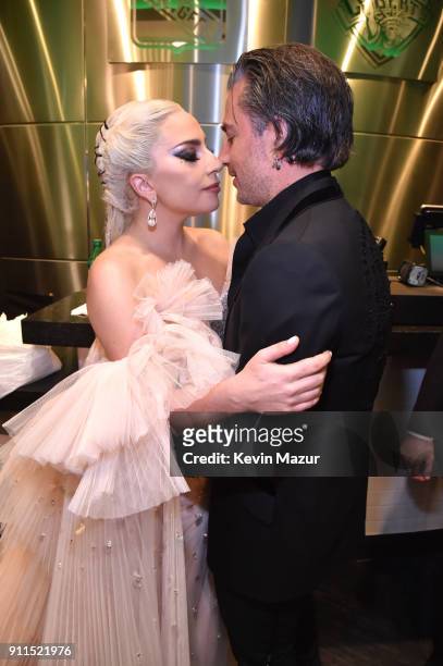 Recording artist Lady Gaga and agent Christian Carino embrace backstage at the 60th Annual GRAMMY Awards at Madison Square Garden on January 28, 2018...
