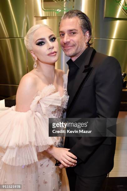 Recording artist Lady Gaga and agent Christian Carino embrace backstage at the 60th Annual GRAMMY Awards at Madison Square Garden on January 28, 2018...