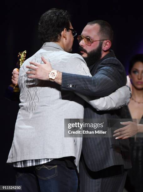 Adult film director/producer Kevin Moore is hugged by adult film director/producer Greg Lansky after Moore spoke about his late wife, adult film...