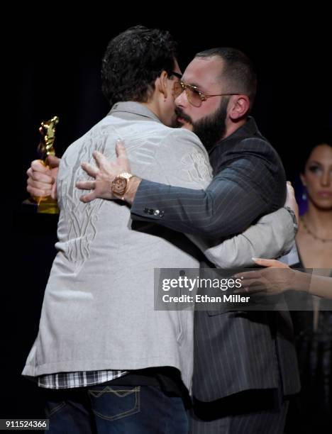 Adult film director/producer Kevin Moore is hugged by adult film director/producer Greg Lansky after Moore spoke about his late wife, adult film...
