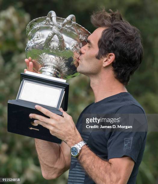 Roger Federer of Switzerland poses with the Norman Brookes Challenge Cup after winning the 2018 Australian Open Men's Singles Final, at Government...