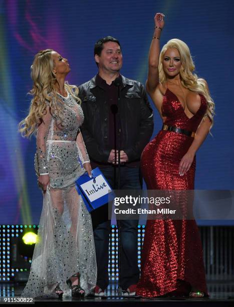 Adult film actress Nikki Benz, comedian/actor Doug Benson and adult film actress Nicolette Shea present an award during the 2018 Adult Video News...