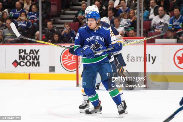 Markus Granlund of the Vancouver Canucks is checked by Jack Eichel of the Buffalo Sabres during their NHL game at Rogers Arena on January 25, 2018 in...