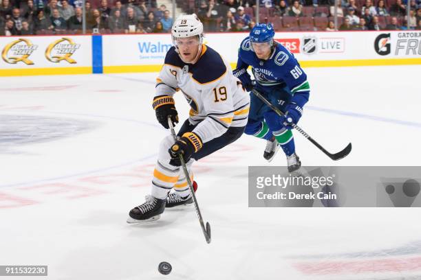 Jake McCabe of the Buffalo Sabres is pursued by Markus Granlund of the Vancouver Canucks during their NHL game at Rogers Arena on January 25, 2018 in...