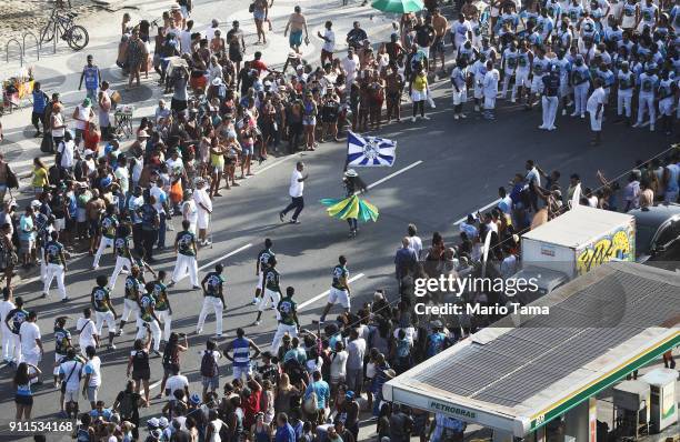 Revelers from the Beija-Flor samba school celebrate during a street practice along Copacabana beach on January 28, 2018 in Rio de Janeiro, Brazil. In...