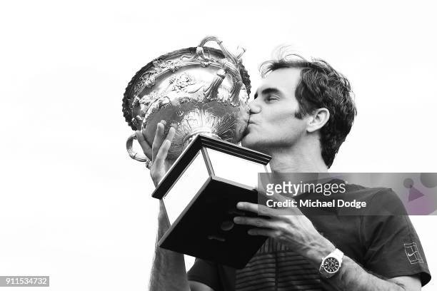 Roger Federer of Switzerland poses with the Norman Brookes Challenge Cup after winning the 2018 Australian Open Men's Singles Final, at Government...