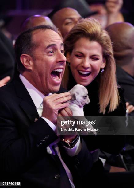 Comedian Jerry Seinfeld receives a consolation puppy during the 60th Annual GRAMMY Awards at Madison Square Garden on January 28, 2018 in New York...