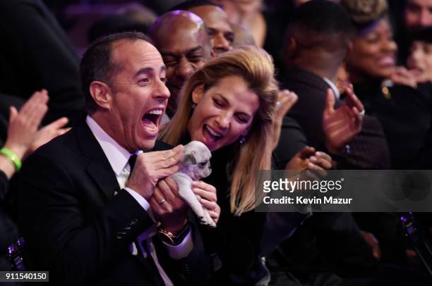 Comedian Jerry Seinfeld receives a consolation puppy during the 60th Annual GRAMMY Awards at Madison Square Garden on January 28, 2018 in New York...