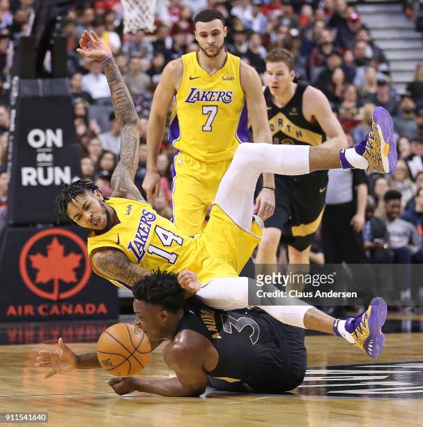 Brandon Ingram of the Los Angeles Lakers is upended by OG Anunoby of the Toronto Raptors in an NBA game at the Air Canada Centre on January 28, 2018...