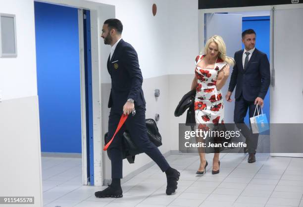 Pamela Anderson and Adil Rami of OM leave the stadium following the French Ligue 1 match between Olympique de Marseille and AS Monaco at Stade...