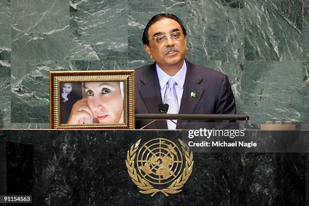 President of Pakistan Asif Ali Zardari holds a photo of his late wife former Prime Minister Benazir Bhutto as he addresses the United Nations General...