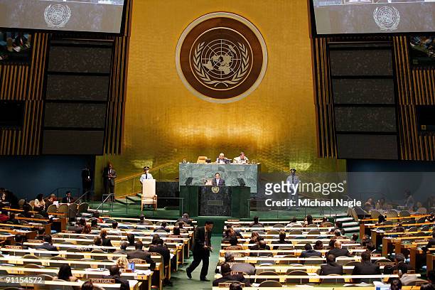 President of Pakistan Asif Ali Zardari holds a photo of his late wife former Prime Minister Benazir Bhutto as he addresses the United Nations General...