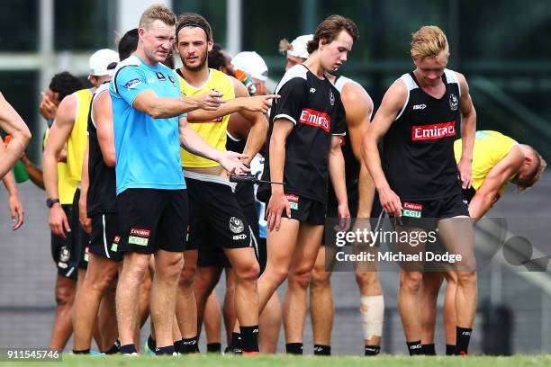 Magpies head coach Nathan Buckley speaks to Tim Broomhead during a Collingwood Magpies AFL training session on January 29, 2018 in Melbourne,...