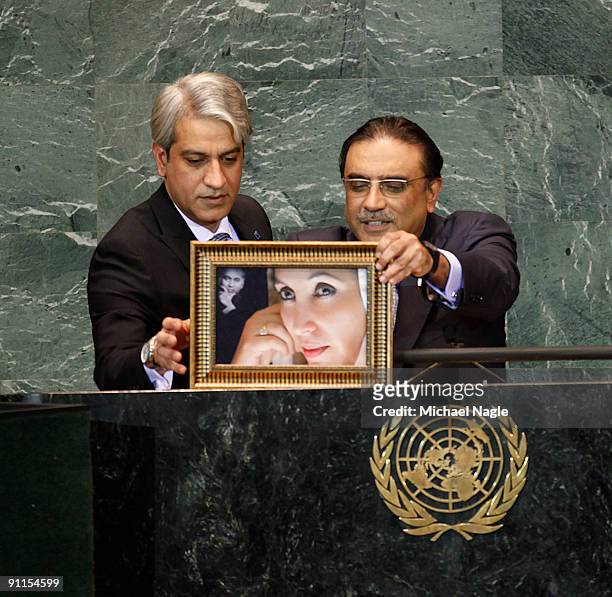 President of Pakistan Asif Ali Zardari holds a photo of his late wife former Prime Minister Benazir Bhutto as he addresses the United Nations General...