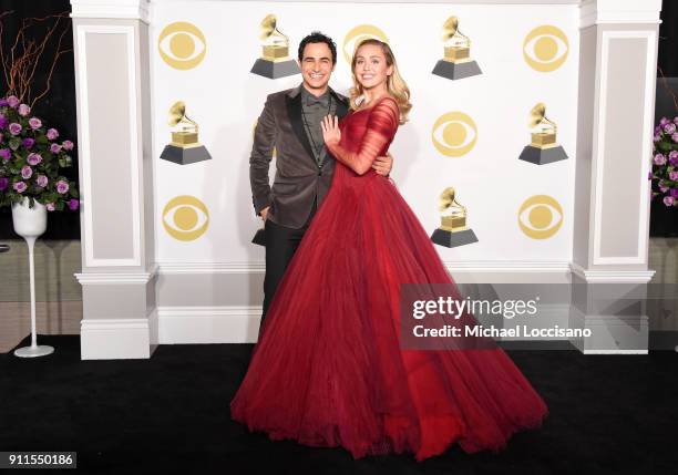 Fashion designer Zac Posen and recording artist Miley Cyrus pose in the press room during the 60th Annual GRAMMY Awards at Madison Square Garden on...