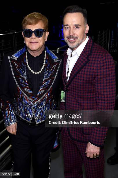 Recording artist Elton John and David Furnish pose backstage during the 60th Annual GRAMMY Awards at Madison Square Garden on January 28, 2018 in New...