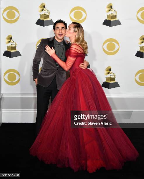 Fashion designer Zac Posen and recording artist Miley Cyrus pose in the press room during the 60th Annual GRAMMY Awards at Madison Square Garden on...