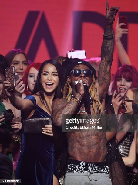 Audience members, including adult film actress Alina Lopez , join rapper Lil' Wayne onstage as he performs during the 2018 Adult Video News Awards at...