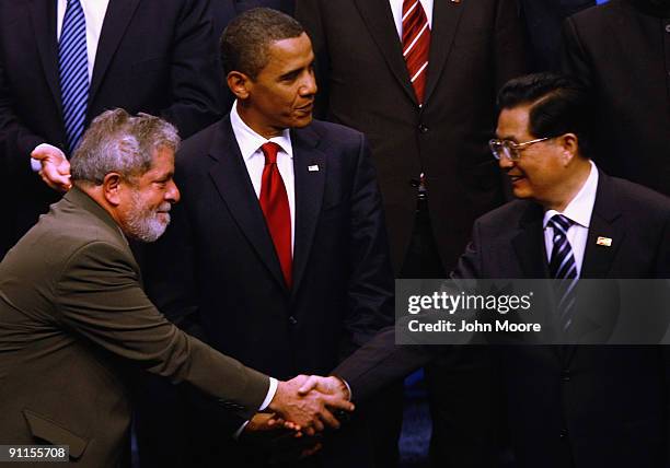 Brazilian President Luiz Inacio Lula da Silva and Chinese President Hu Jintao shake hands after posing with fellow world leaders for the offical...