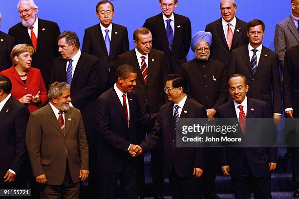 President Barack Obama shakes hands with Chinese President Hujin Tao after posing for the official group photo at the G-20 as Director General of the...